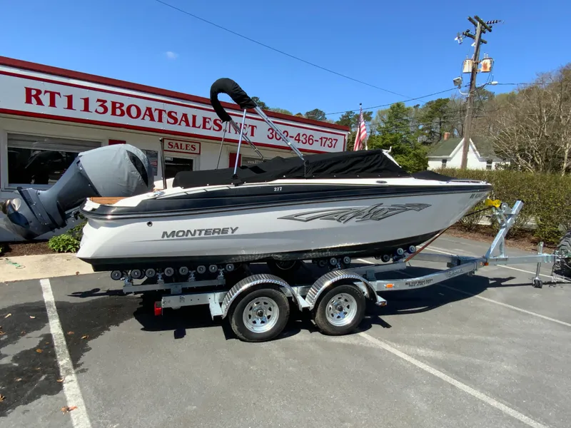 Slide: The Image of 2017 Monterey 217 Outboard boat on trailer at dealership parking lot. - 21