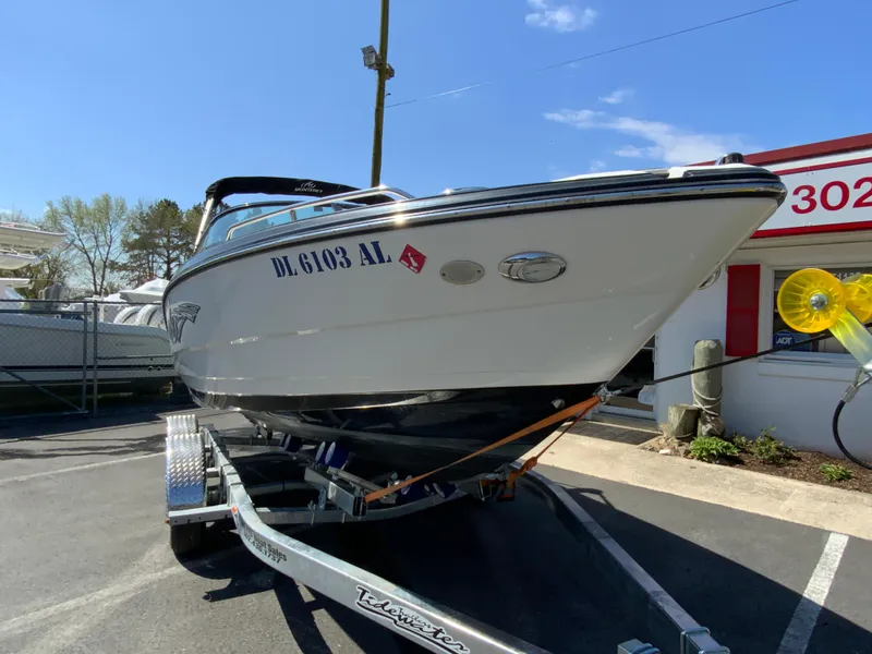 Slide: The Image of 2017 Monterey 217 Outboard boat on trailer, parked outdoors under clear sky. - 3