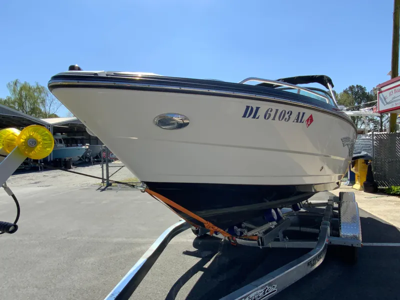 Slide: The Image of 2017 Monterey 217 Outboard boat on trailer, parked outdoors under clear sky. - 4