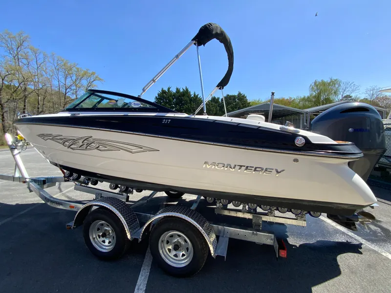 Slide: The Image of 2017 Monterey 217 Outboard boat on trailer under clear blue sky. - 6