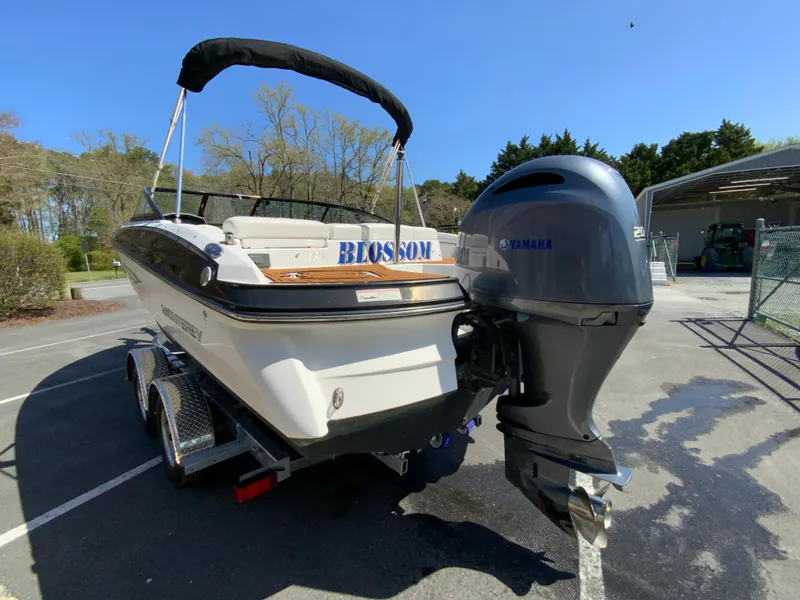 Slide: The Image of 2017 Monterey 217 Outboard boat with Yamaha engine on trailer in sunny outdoor setting. - 7