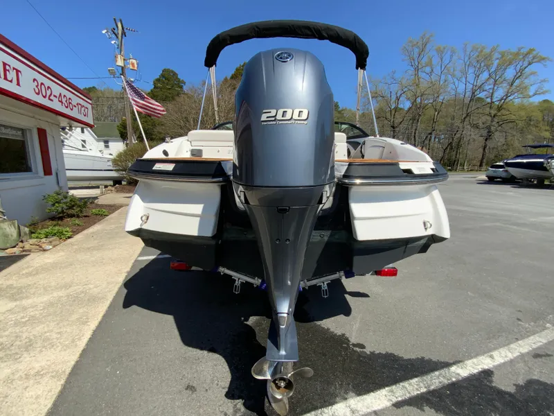Slide: The Image of 2017 Monterey 217 Outboard boat with 200 HP engine, parked outdoors. - 8