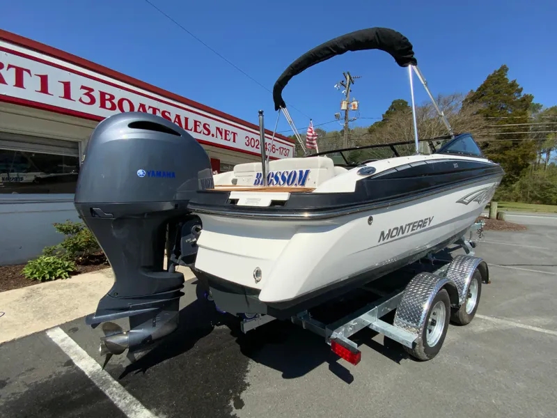 Slide: The Image of 2017 Monterey 217 Outboard boat on trailer, parked outside a boat sales shop. - 9