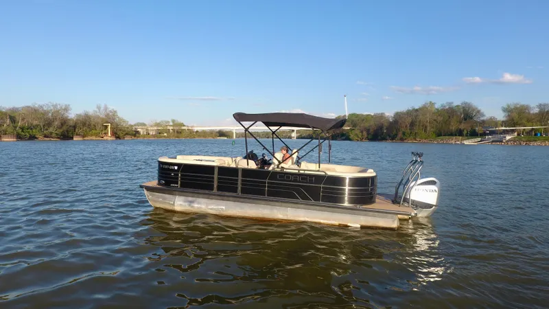 Slide: The Image of 2019 Coach Pontoons 230 RF on a serene lake under clear blue skies. - 3
