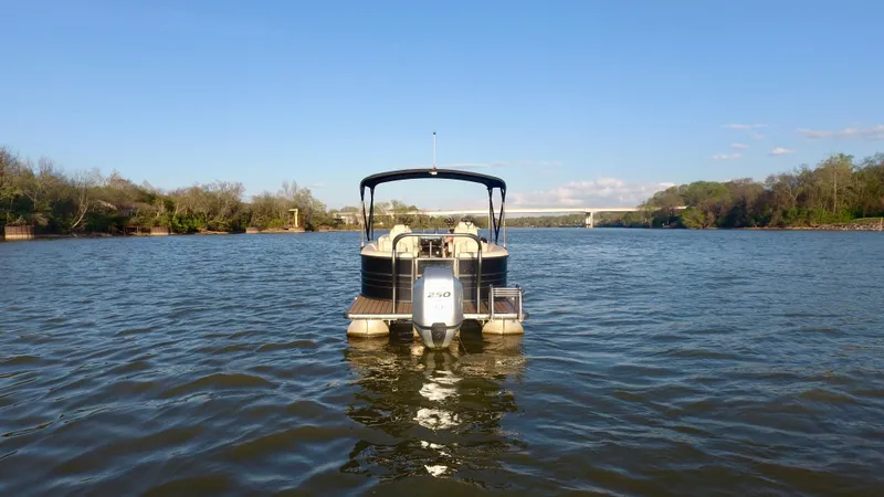 Slide: The Image of 2019 Coach Pontoons 230 RF on a serene lake with clear blue sky. - 5