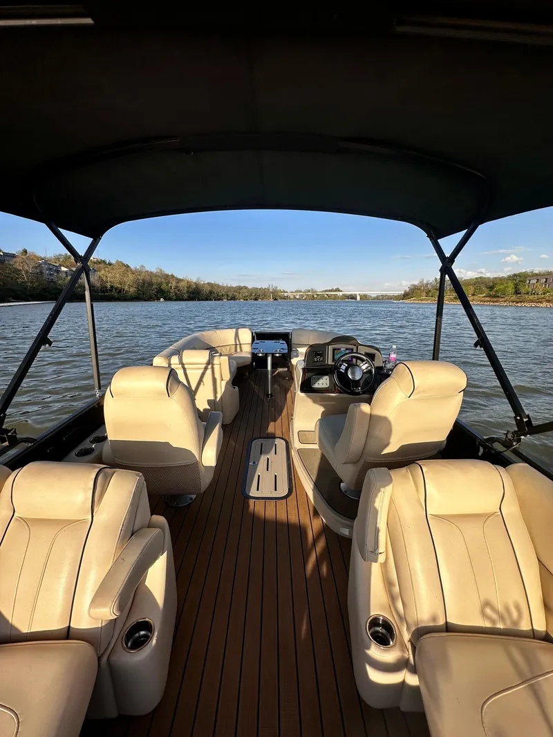 Slide: The Image of 2019 Coach Pontoons 230 RF on a serene lake, featuring luxurious seating and a sleek design. - 9
