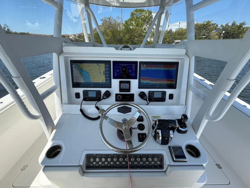 Slide: The Image of 2022 Invincible 33 Catamaran helm with advanced navigation and control systems. - 11