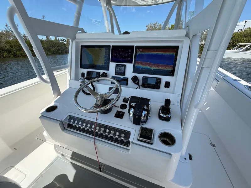 Slide: The Image of 2022 Invincible 33 Catamaran helm with advanced navigation and control systems. - 12