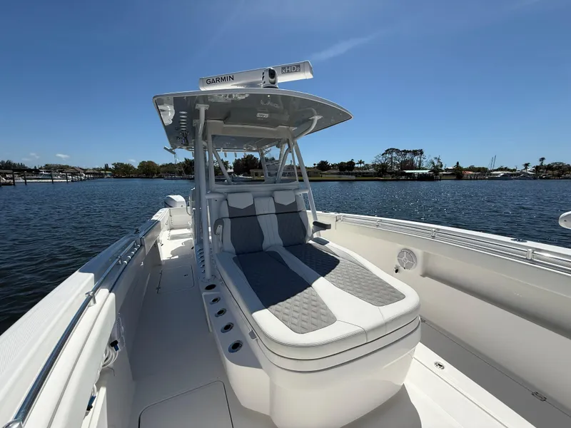 Slide: The Image of 2022 Invincible 33 Catamaran on water, featuring sleek design and comfortable seating. - 16