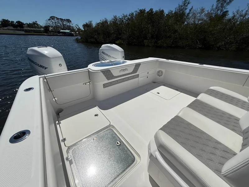 Slide: The Image of 2022 Invincible 33 Catamaran boat interior with seating and twin outboard motors. - 7