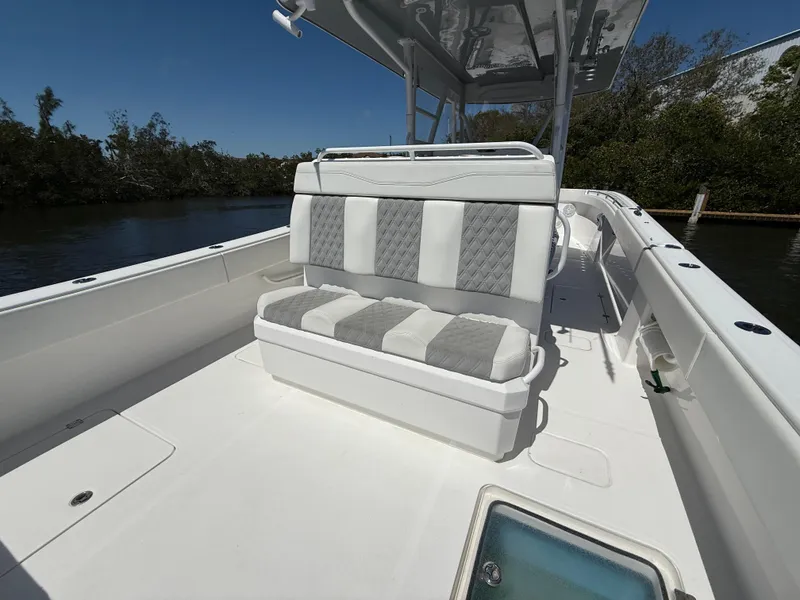 Slide: The Image of 2022 Invincible 33 Catamaran with cushioned seating, sleek design, and spacious deck. - 8