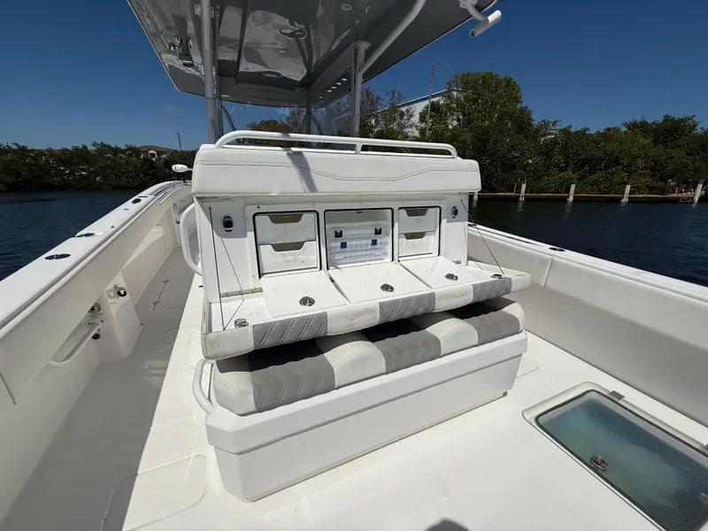 Slide: The Image of 2022 Invincible 33 Catamaran interior with seating and storage, docked by the water. - 9