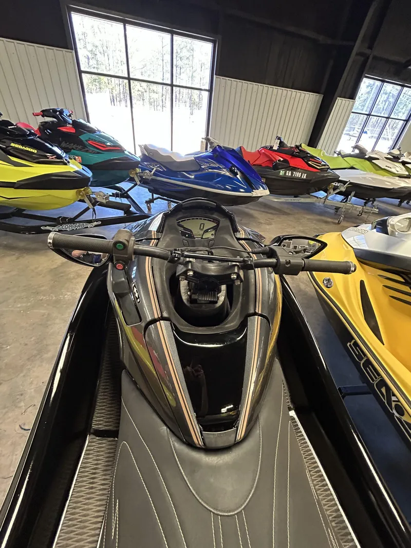 Slide: The Image of 2019 Kawasaki Jet Ski Ultra LX in showroom with other colorful jet skis. - 6