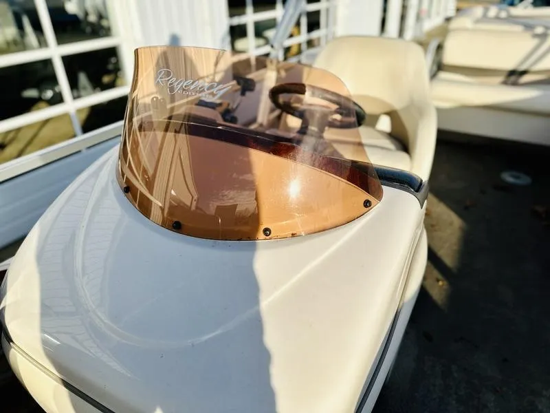 Slide: The Image of 2006 Sun Tracker PARTY BARGE boat with steering wheel and tinted windshield. - 13