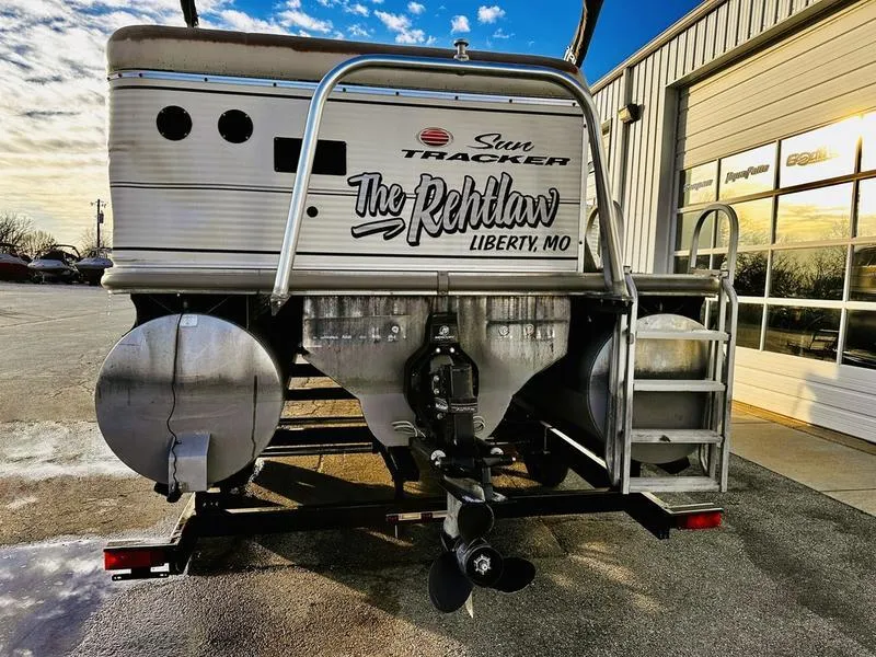 Slide: The Image of 2006 Sun Tracker PARTY BARGE pontoon boat rear view with custom lettering, parked outdoors. - 22