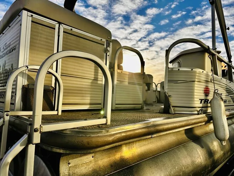 Slide: The Image of 2006 Sun Tracker PARTY BARGE pontoon boat under a vibrant sky. - 23