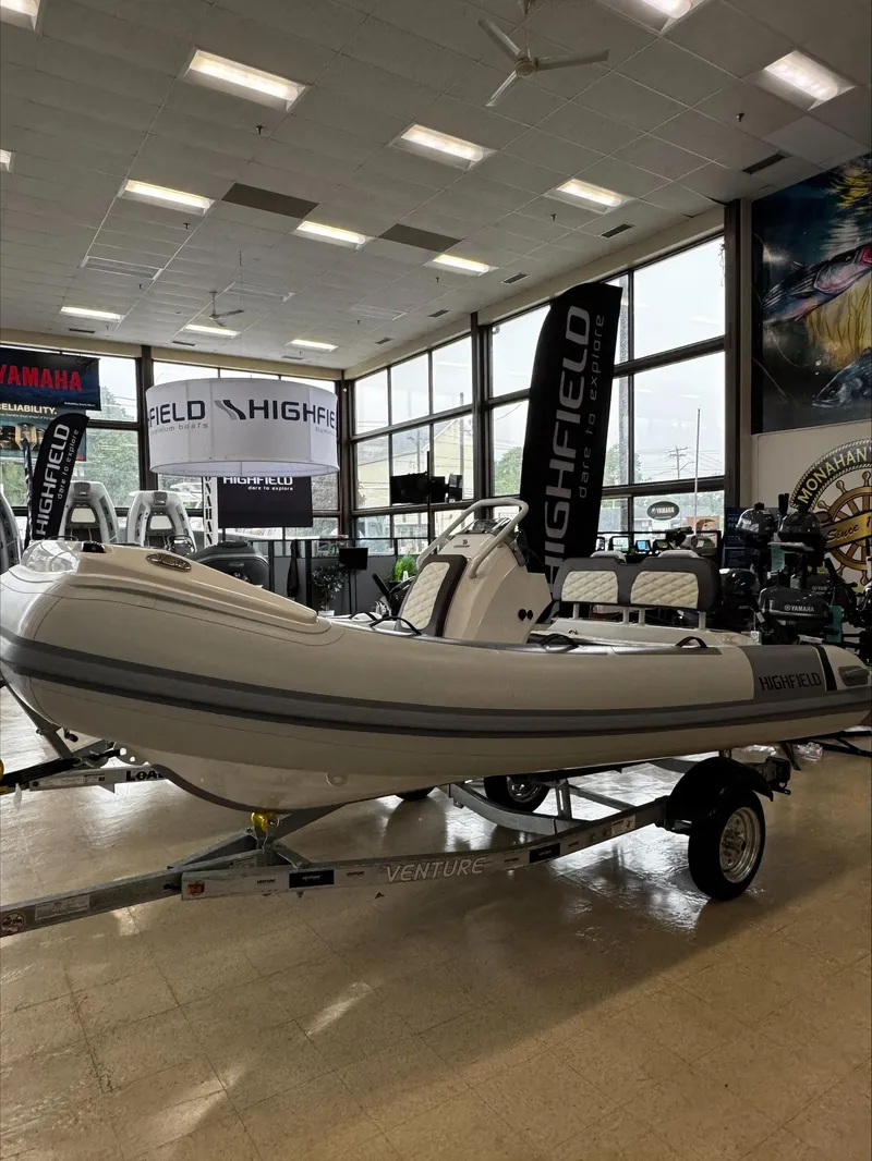 The Image of 2025 Highfield Sport 390 boat displayed indoors on a trailer. - 0