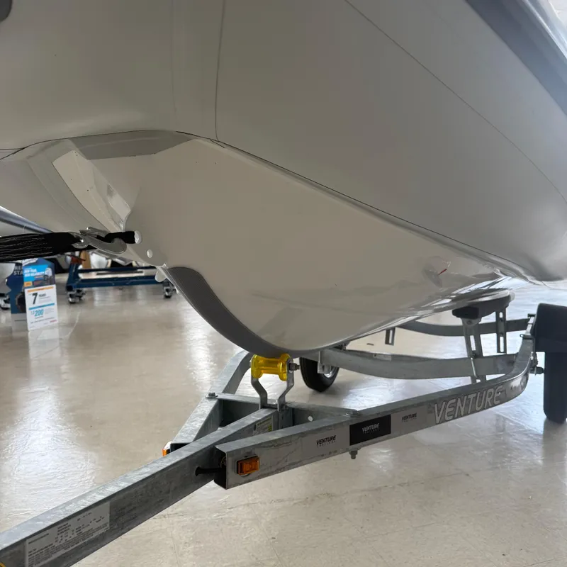 Slide: The Image of 2025 Highfield Sport 390 boat on trailer, close-up of bow and handle. - 7
