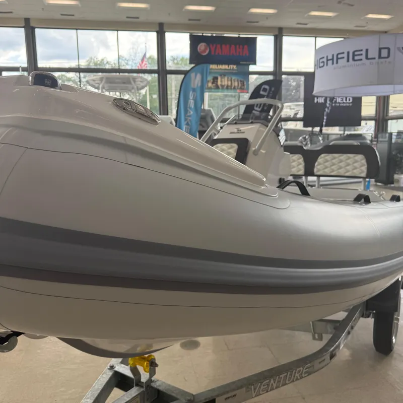 Slide: The Image of 2025 Highfield Sport 390 boat on Venture trailer in showroom. - 8