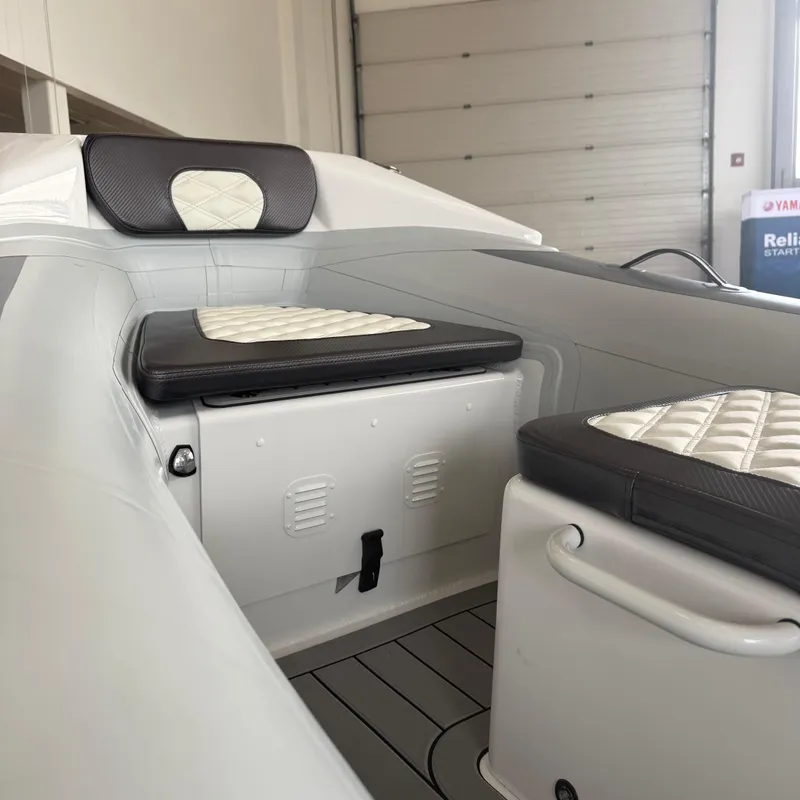 Slide: The Image of 2025 Highfield Sport 390 boat displayed indoors on a trailer. - 9