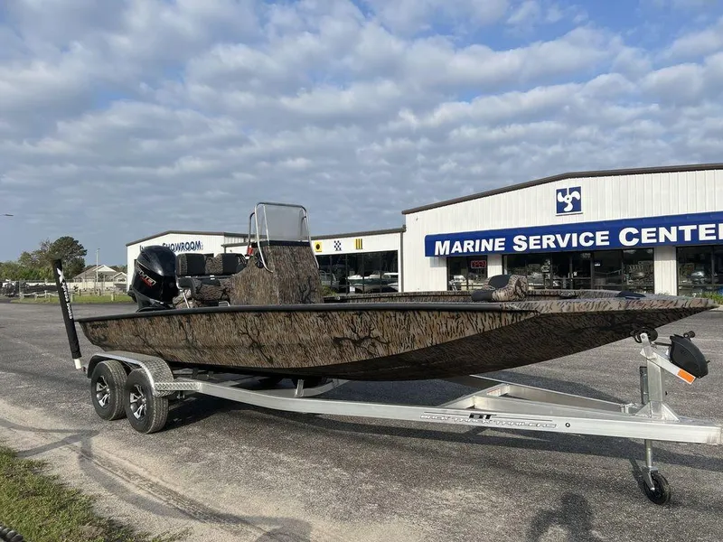 Slide: The Image of 2025 Xpress H210 BAY boat on trailer outside Marine Service Center. - 11
