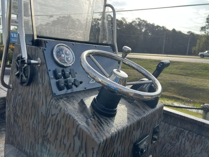 Slide: The Image of Steering console of 2025 Xpress H210 BAY boat with controls and gauges. - 2