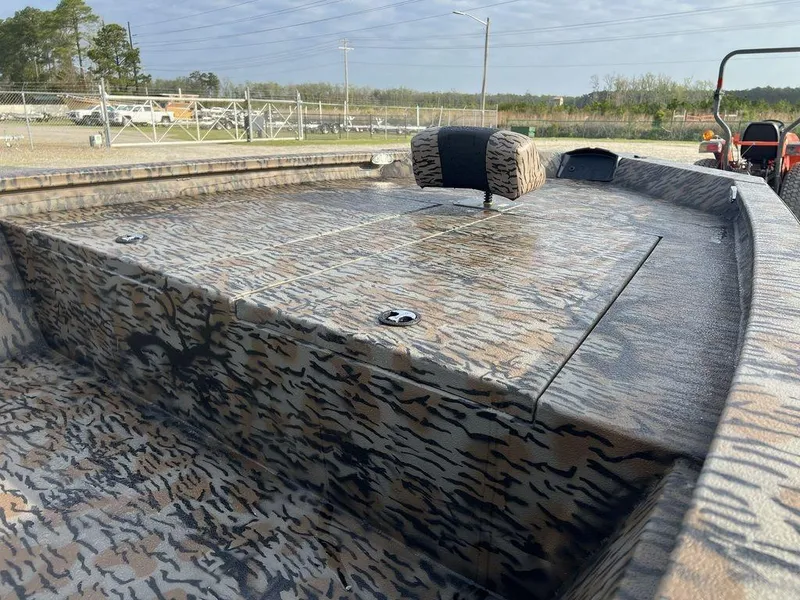 Slide: The Image of 2025 Xpress H210 BAY boat with camouflage pattern, featuring spacious deck and seating. - 3