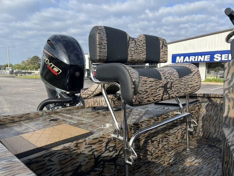 Slide: The Image of 2025 Xpress H210 BAY boat with camo seating and powerful outboard motor. - 4