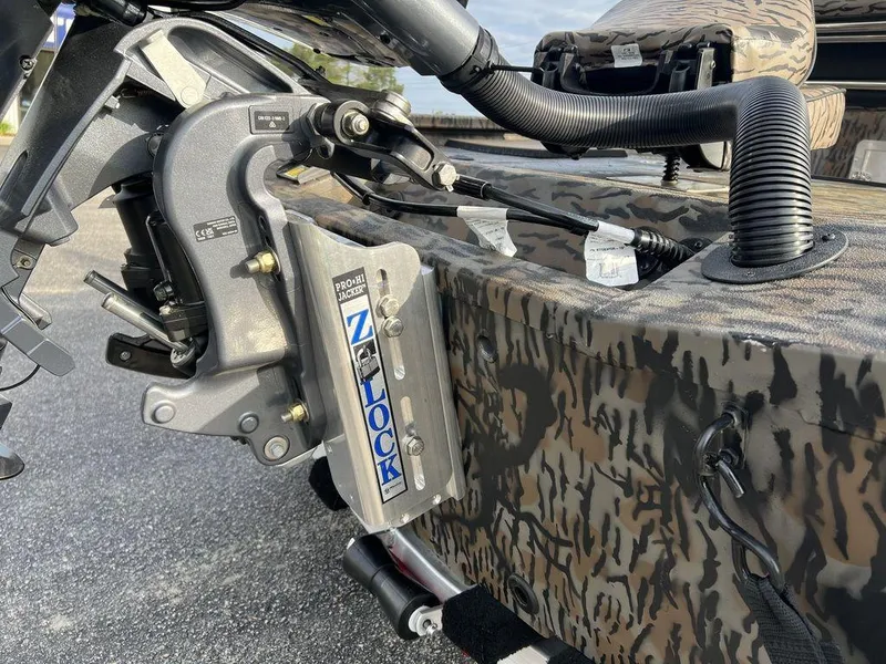 Slide: The Image of 2025 Xpress H210 BAY boat with camouflage design and hydraulic components. - 7