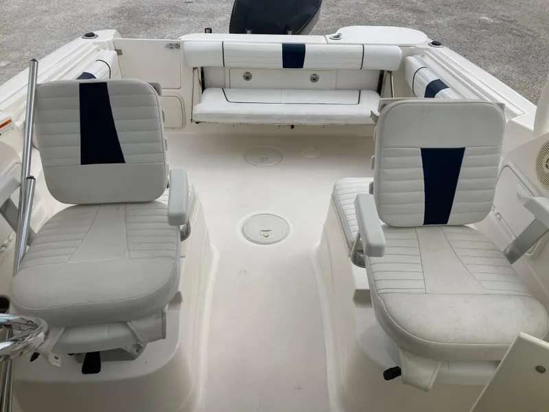 Slide: The Image of 2014 Wellcraft 232 Coastal boat interior with white seating and blue accents. - 16