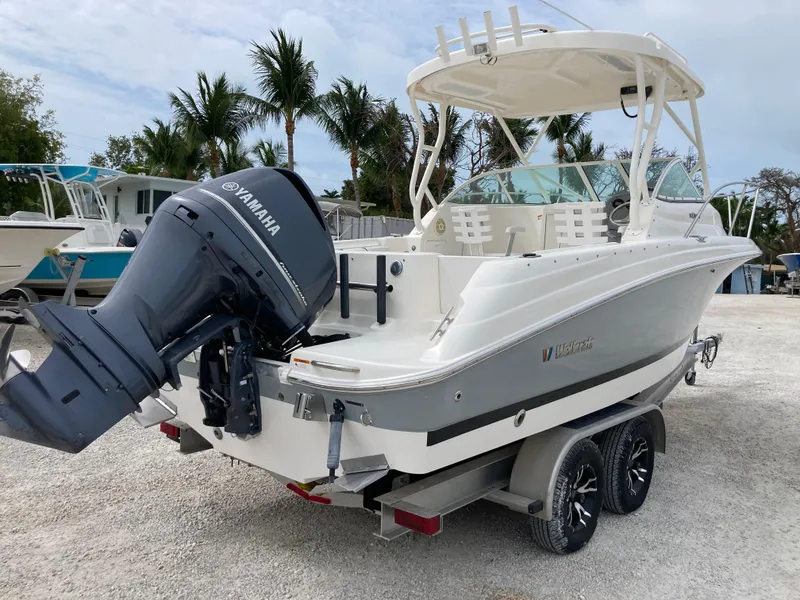 Slide: The Image of 2014 Wellcraft 232 Coastal boat on trailer with Yamaha outboard motor, parked outdoors. - 3