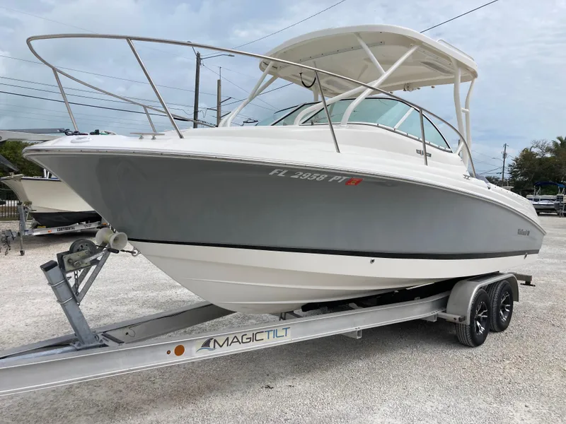 Slide: The Image of 2014 Wellcraft 232 Coastal boat on trailer, parked outdoors. - 5