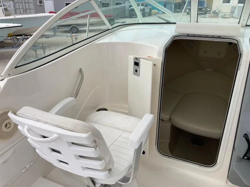 Slide: The Image of 2014 Wellcraft 232 Coastal boat interior with seating and cabin entrance. - 7