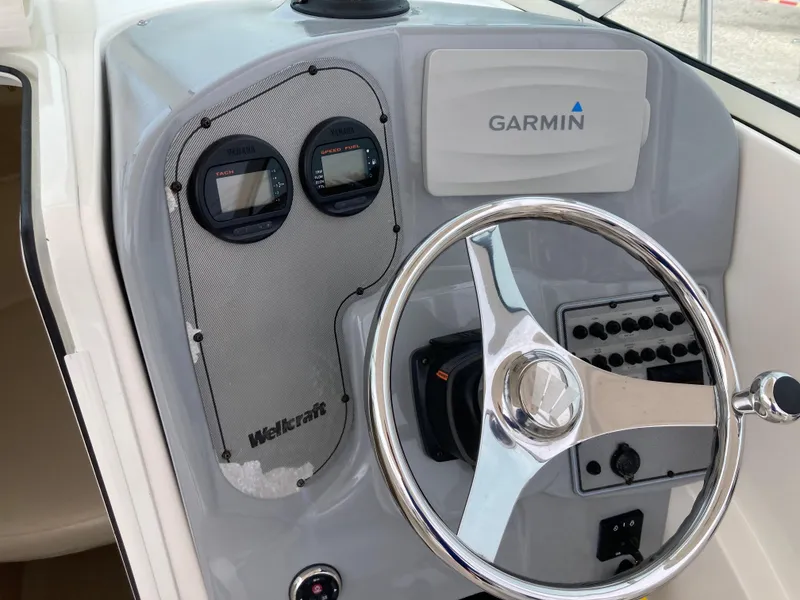 Slide: The Image of Control panel of 2014 Wellcraft 232 Coastal boat with Garmin navigation system. - 9