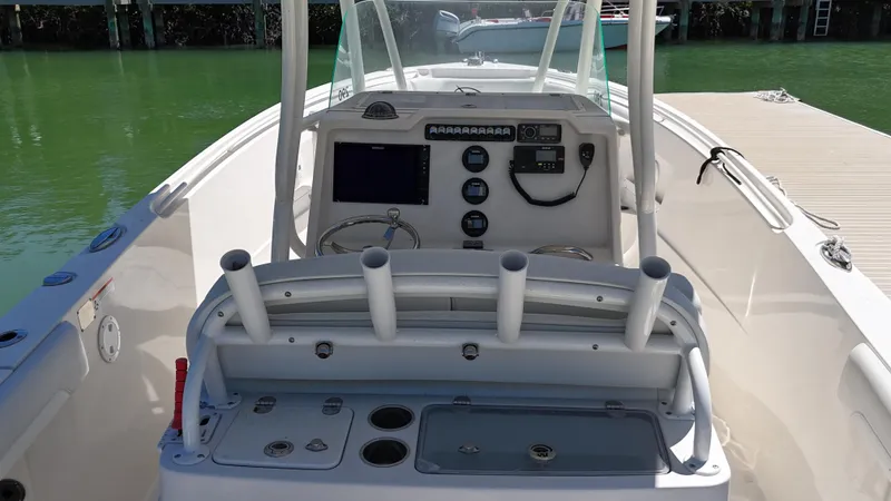 Slide: The Image of 2015 Sailfish 290cc boat cockpit with control panel and rod holders. - 11