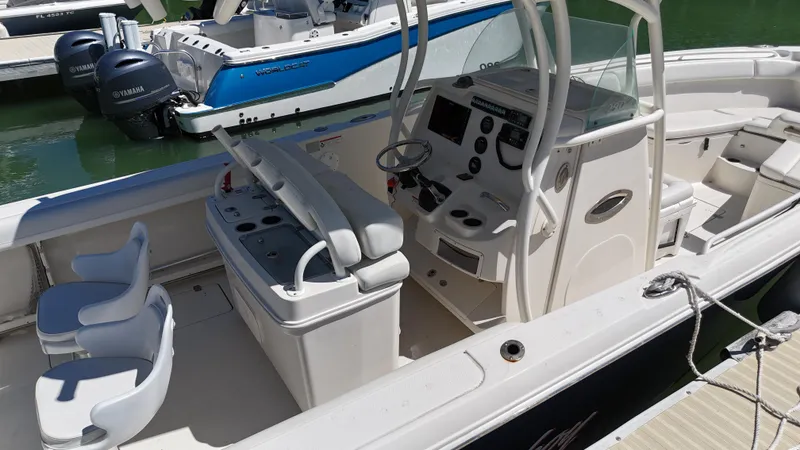 Slide: The Image of 2015 Sailfish 290cc boat interior with helm, seating, and controls. - 9