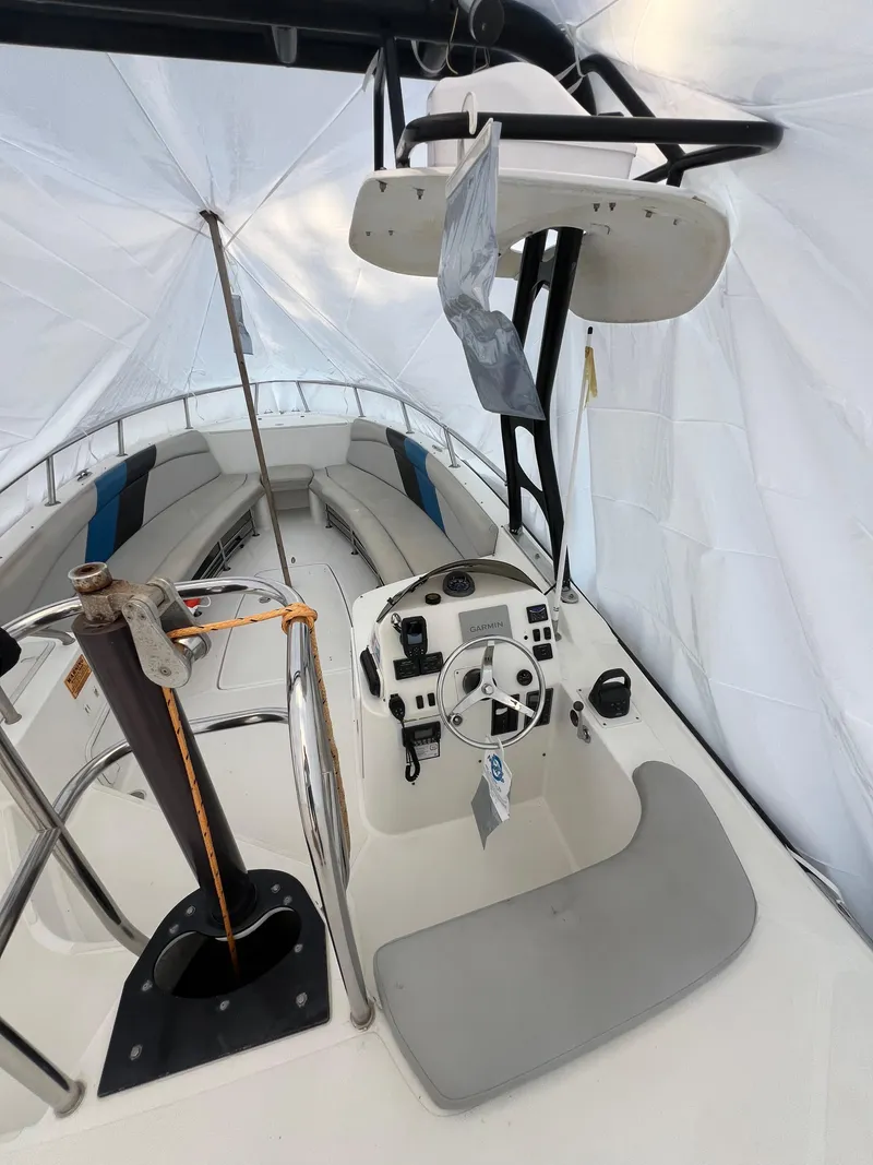 Slide: The Image of 2010 Centurion Parasail Boat interior with steering wheel and controls under a protective cover. - 10