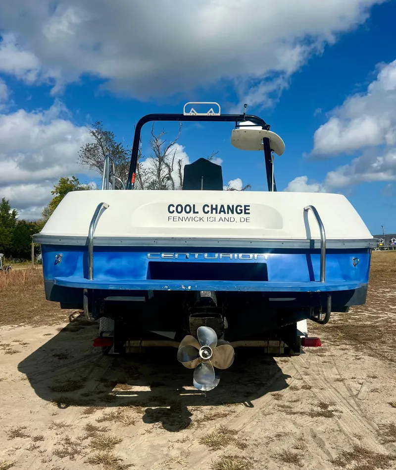 Slide: The Image of 2010 Centurion Parasail Boat on sandy terrain under blue sky. - 3