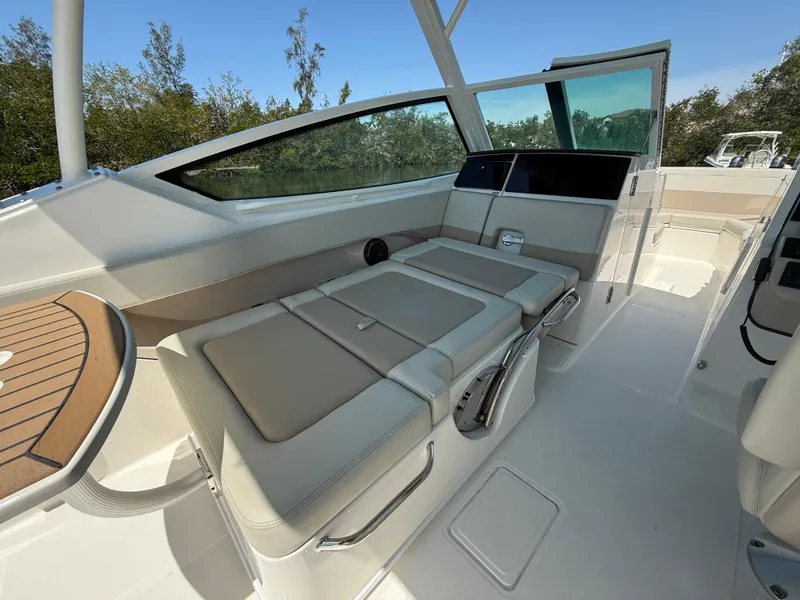 Slide: The Image of 2023 Boston Whaler 280 Vantage interior with beige seating and sleek design. - 15