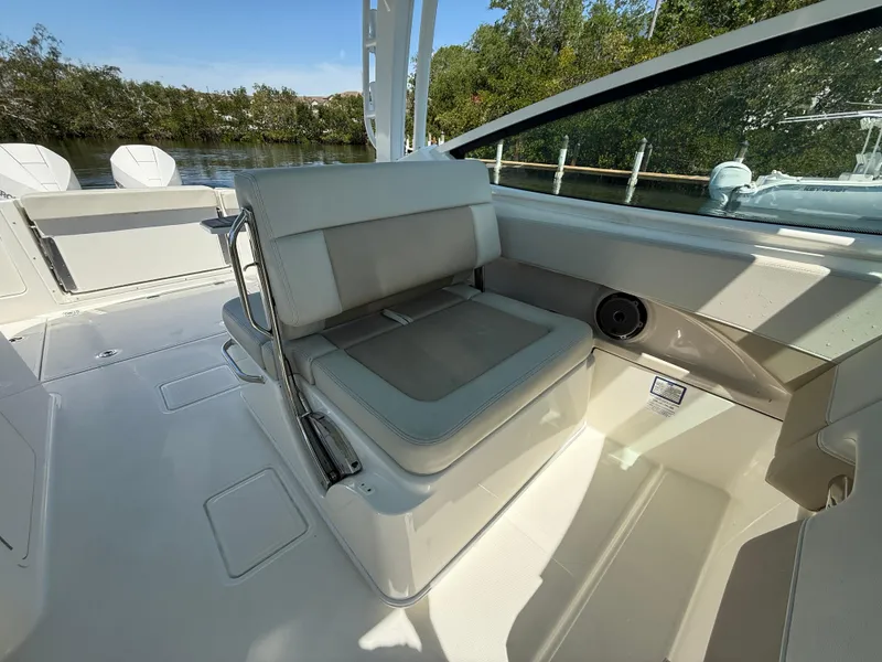 Slide: The Image of 2023 Boston Whaler 280 Vantage boat interior with cushioned seating and sleek design. - 17