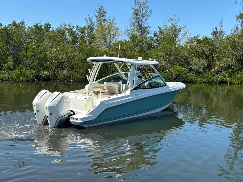 Slide: The Image of 2023 Boston Whaler 280 Vantage boat cruising on a calm river. - 2