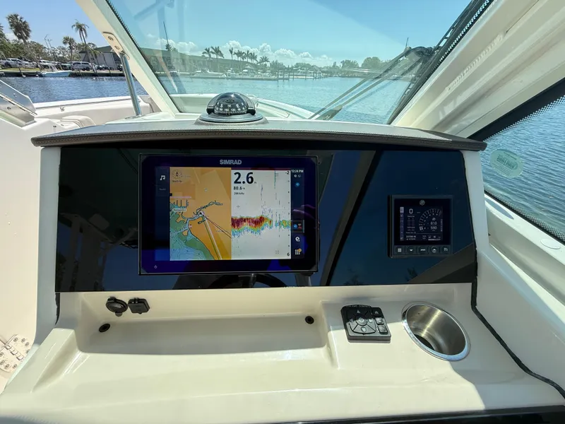 Slide: The Image of 2023 Boston Whaler 280 Vantage dashboard with navigation display and controls. - 20