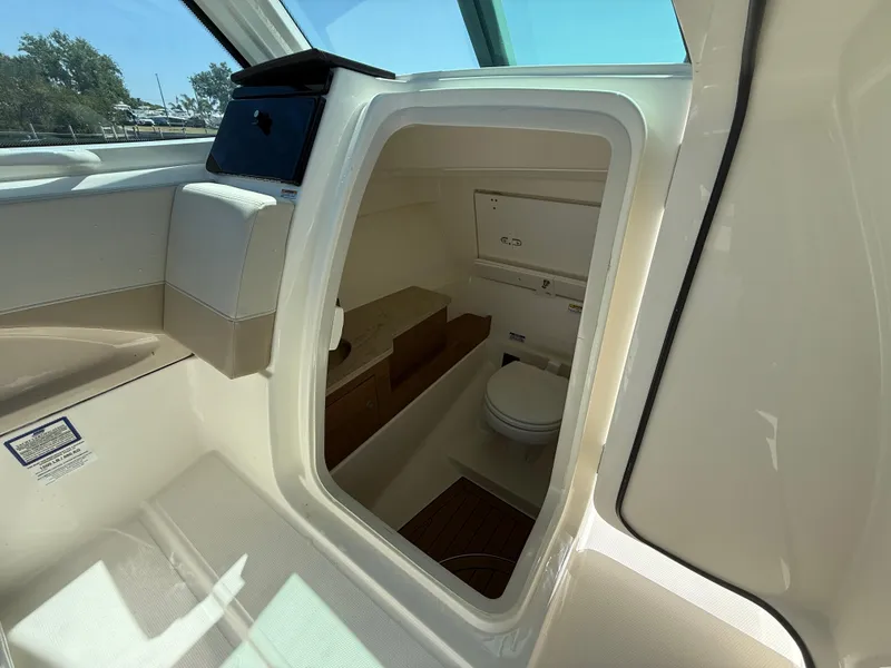 Slide: The Image of 2023 Boston Whaler 280 Vantage boat interior with compact bathroom amenities. - 23
