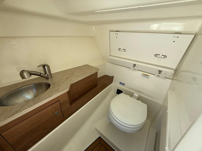 Slide: The Image of 2023 Boston Whaler 280 Vantage boat interior with sink and toilet. - 24