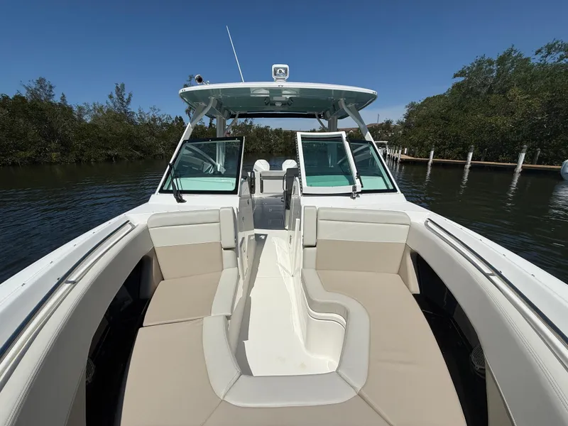 Slide: The Image of 2023 Boston Whaler 280 Vantage boat with spacious seating and sleek design on calm water. - 26