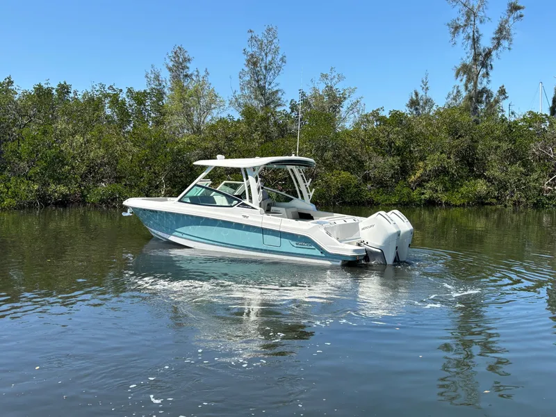 Slide: The Image of 2023 Boston Whaler 280 Vantage boat cruising on a calm, scenic waterway. - 5