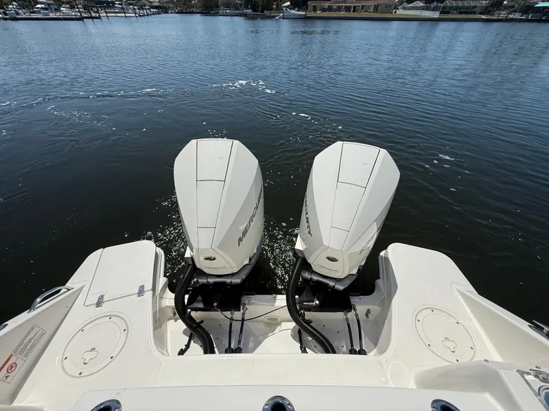 Slide: The Image of 2023 Boston Whaler 280 Vantage with dual outboard engines on calm water. - 9