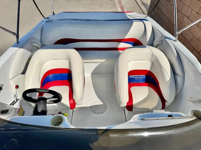 Slide: The Image of 2002 Baja 24H2X boat interior with red and blue accented seats and steering wheel. - 10