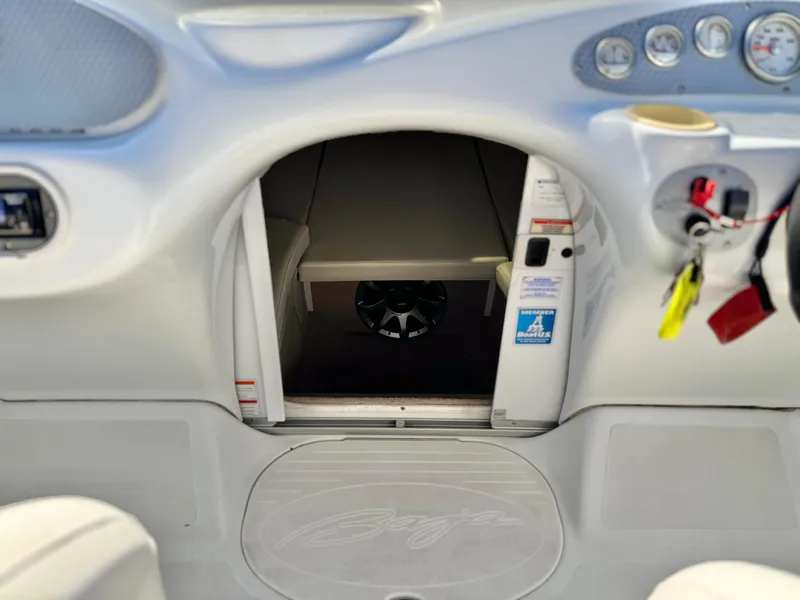 Slide: The Image of 2002 Baja 24H2X boat interior with dashboard, gauges, and cabin entrance. - 16