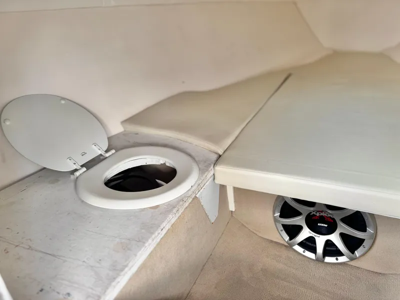 Slide: The Image of 2002 Baja 24H2X boat interior with speaker and storage compartment. - 18